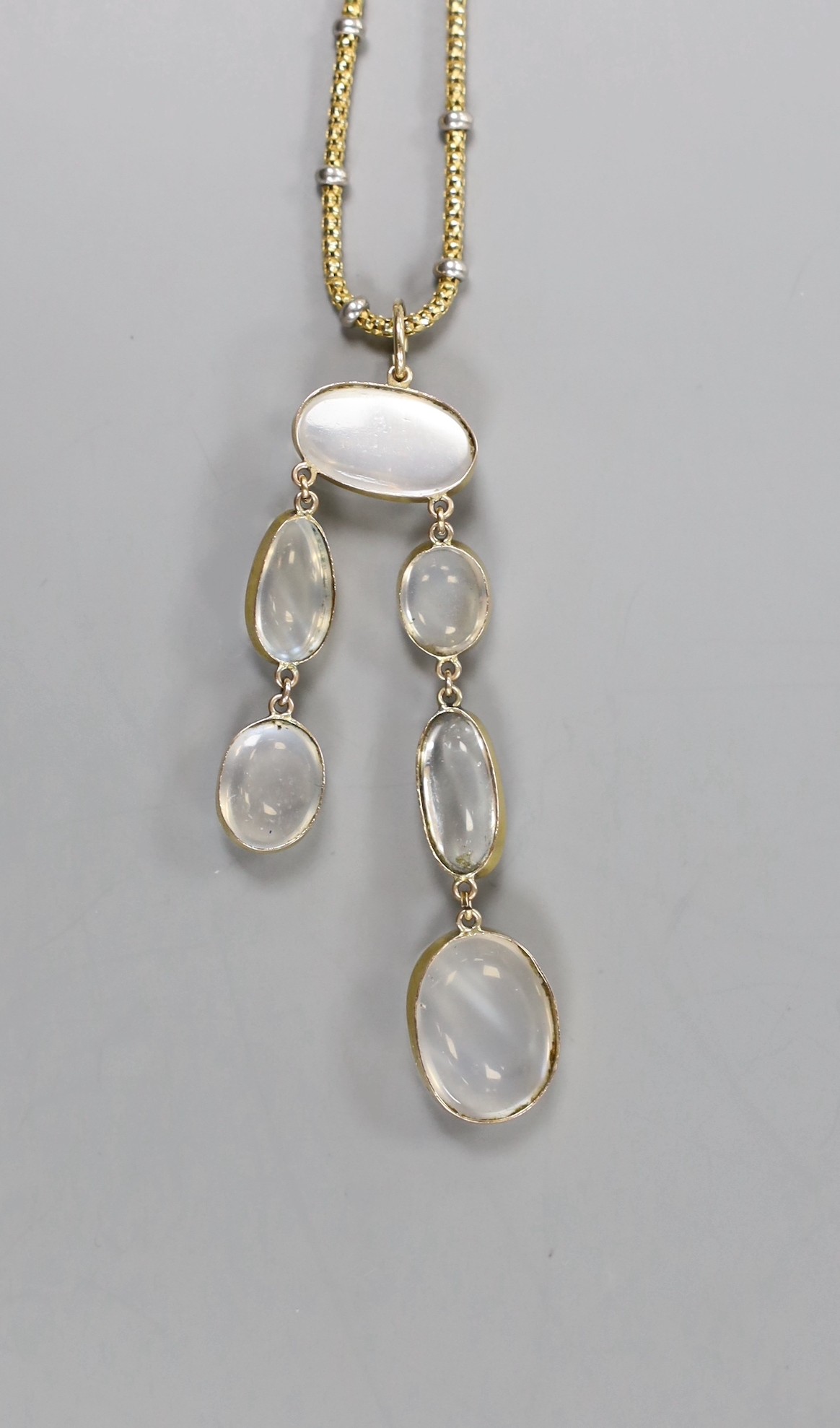 A 375 and six stone cabochon moonstone set drop necklace, with white metal spacers, approx. 60cm, gross weight 10.4 grams.